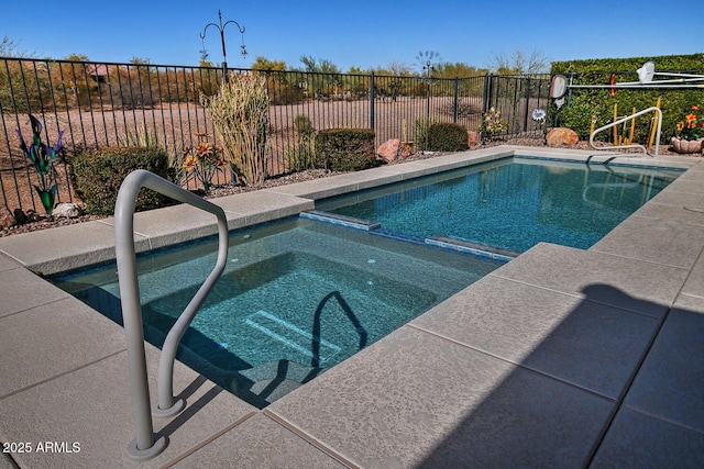 view of swimming pool with an in ground hot tub