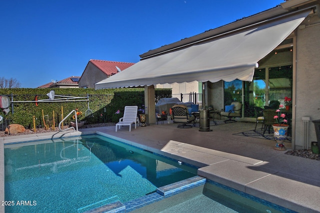 view of swimming pool featuring a patio