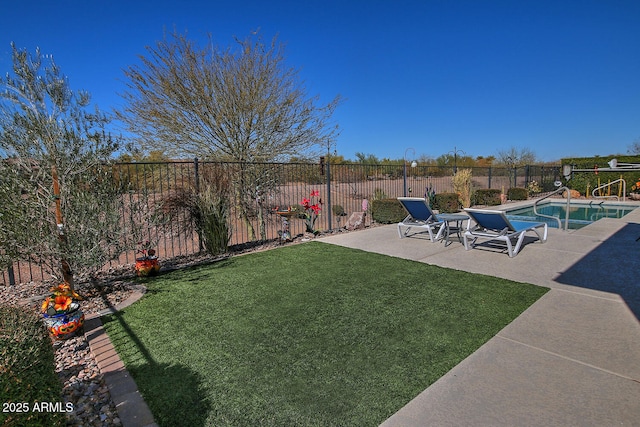 view of yard featuring a fenced in pool and a patio