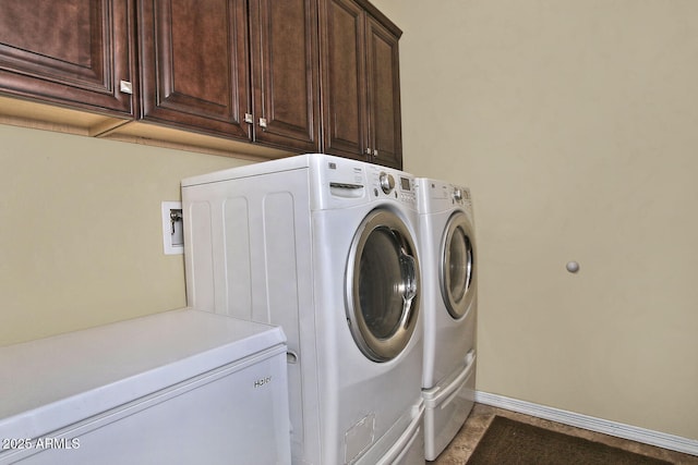 washroom with cabinets and separate washer and dryer