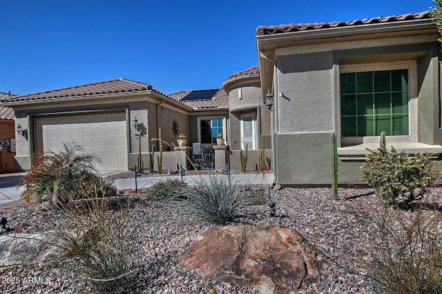 view of front of house featuring a garage and solar panels