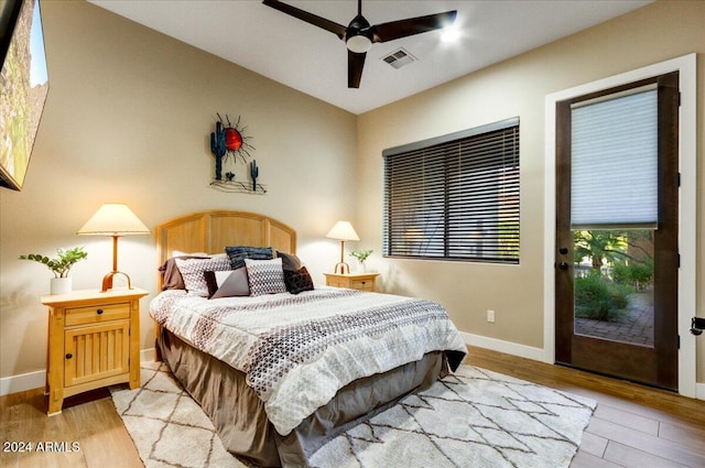 bedroom with ceiling fan, access to exterior, vaulted ceiling, and light hardwood / wood-style floors