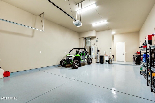 garage with a garage door opener and strapped water heater