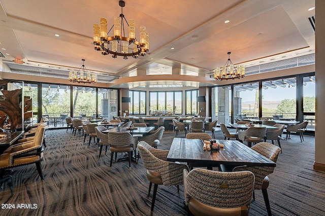 dining space with a wealth of natural light, an inviting chandelier, and dark colored carpet