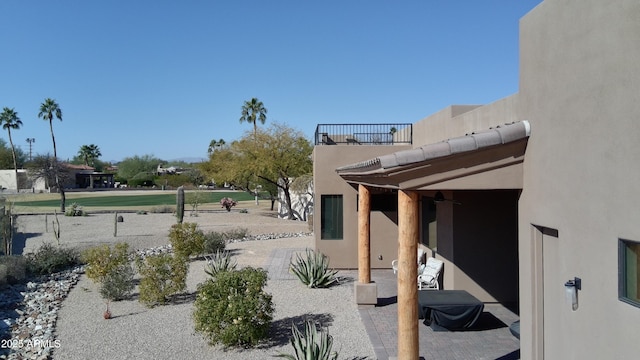 view of yard with a balcony