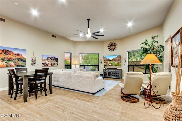 living room featuring ceiling fan and light hardwood / wood-style flooring