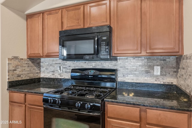 kitchen with black appliances, decorative backsplash, brown cabinetry, and dark stone countertops