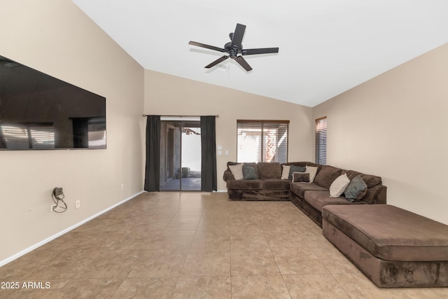 living room with a ceiling fan, vaulted ceiling, baseboards, and light tile patterned floors