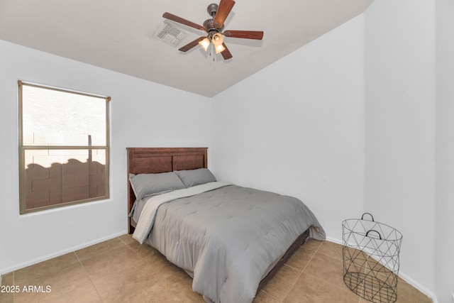 bedroom featuring vaulted ceiling, light tile patterned floors, visible vents, and baseboards