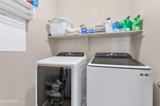 washroom featuring laundry area and washing machine and dryer