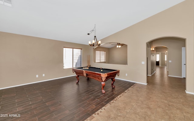 rec room with arched walkways, wood finished floors, visible vents, baseboards, and vaulted ceiling