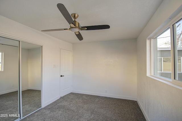 unfurnished bedroom featuring ceiling fan, carpet flooring, and a closet