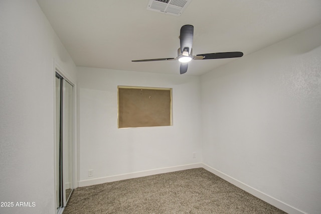 empty room with ceiling fan and carpet flooring