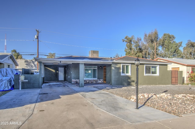 single story home featuring a carport