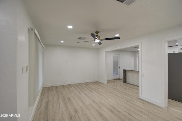 unfurnished living room featuring ceiling fan and light hardwood / wood-style floors