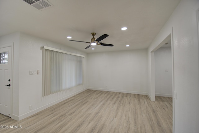 spare room with light hardwood / wood-style floors and ceiling fan