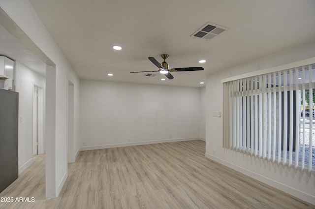 spare room with ceiling fan and light wood-type flooring