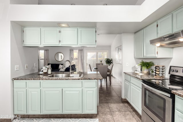 kitchen with stainless steel range with electric cooktop, light tile patterned flooring, sink, white cabinetry, and kitchen peninsula