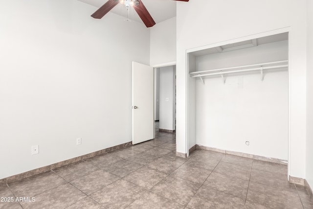 unfurnished bedroom featuring tile patterned floors, a closet, and ceiling fan