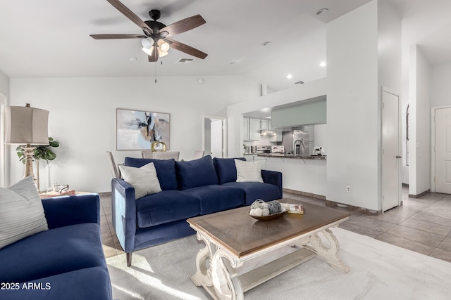 tiled living room with vaulted ceiling and ceiling fan