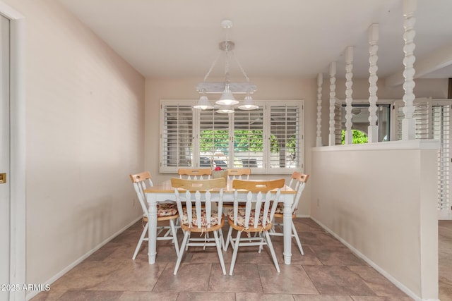 dining area featuring baseboards and stone finish flooring