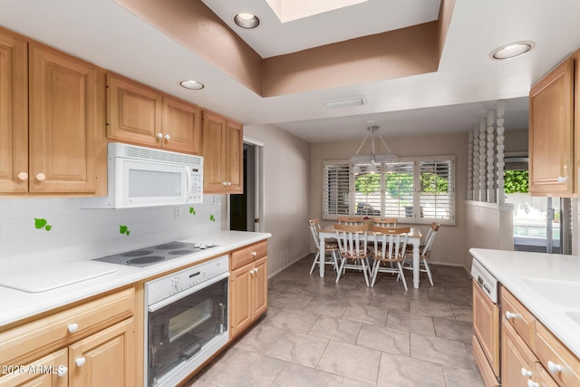 kitchen with white appliances, baseboards, light countertops, decorative backsplash, and recessed lighting
