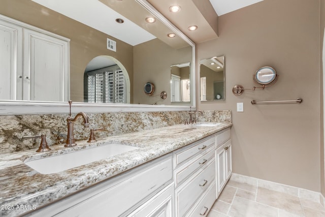 full bath with double vanity, baseboards, and recessed lighting