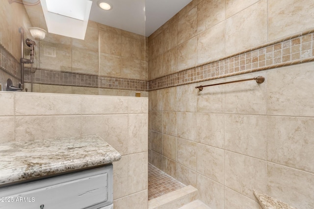 bathroom view of a tile shower and recessed lighting