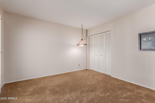 unfurnished room featuring carpet floors and baseboards