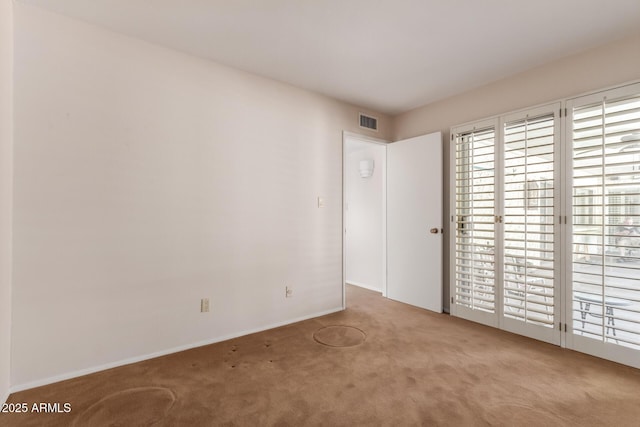 carpeted spare room with baseboards