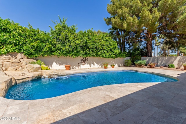 view of pool with a fenced backyard and a patio area