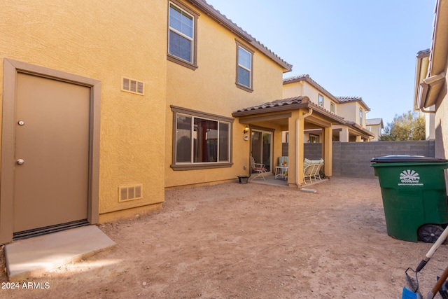 back of house with a patio