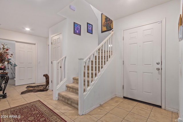 entryway with light tile patterned flooring