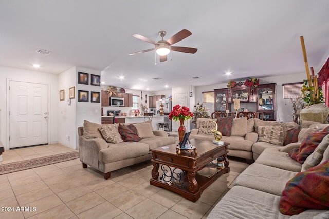 tiled living room featuring ceiling fan