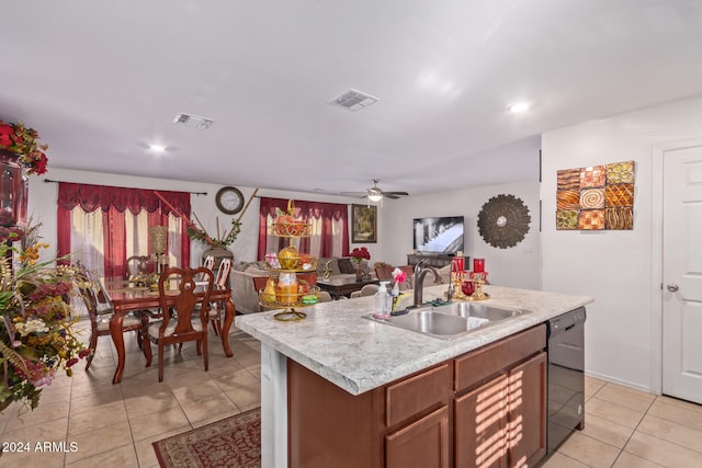 kitchen with ceiling fan, sink, black dishwasher, a kitchen island with sink, and light tile patterned floors