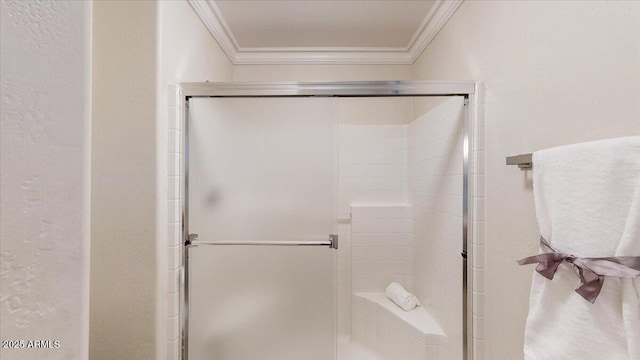 bathroom featuring a shower with door and ornamental molding