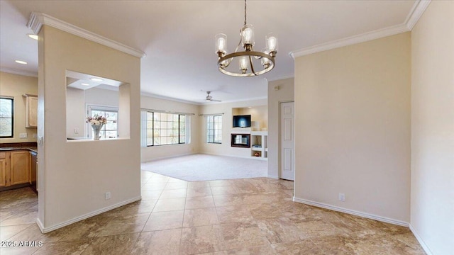 interior space featuring crown molding and ceiling fan with notable chandelier