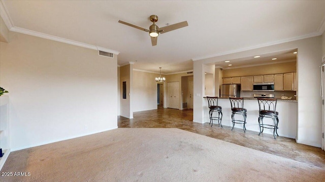 kitchen featuring a kitchen bar, light brown cabinetry, crown molding, appliances with stainless steel finishes, and kitchen peninsula