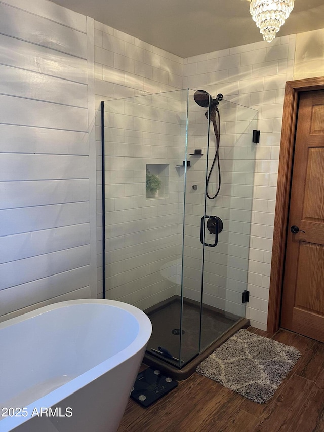1420 S Haystack Rd, Taylor, AZ 85939 - bathroom featuring wood finished floors, a shower stall, and a soaking tub