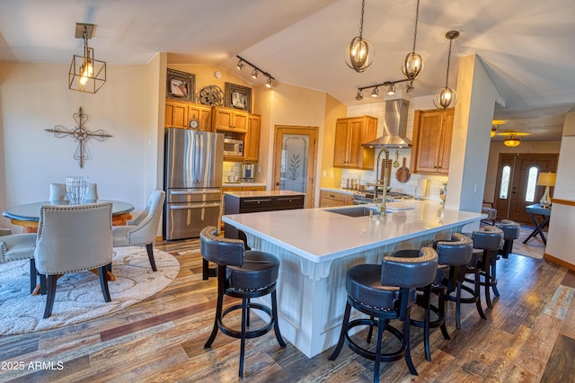 1420 S Haystack Rd, Taylor, AZ 85939 - kitchen with appliances with stainless steel finishes, wall chimney range hood, dark wood finished floors, vaulted ceiling, and light countertops