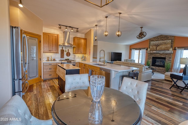 1420 S Haystack Rd, Taylor, AZ 85939 - kitchen featuring wall chimney range hood, stainless steel appliances, lofted ceiling, dark wood finished floors, and butcher block countertops
