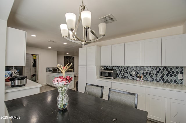 dining space featuring an inviting chandelier, visible vents, and recessed lighting