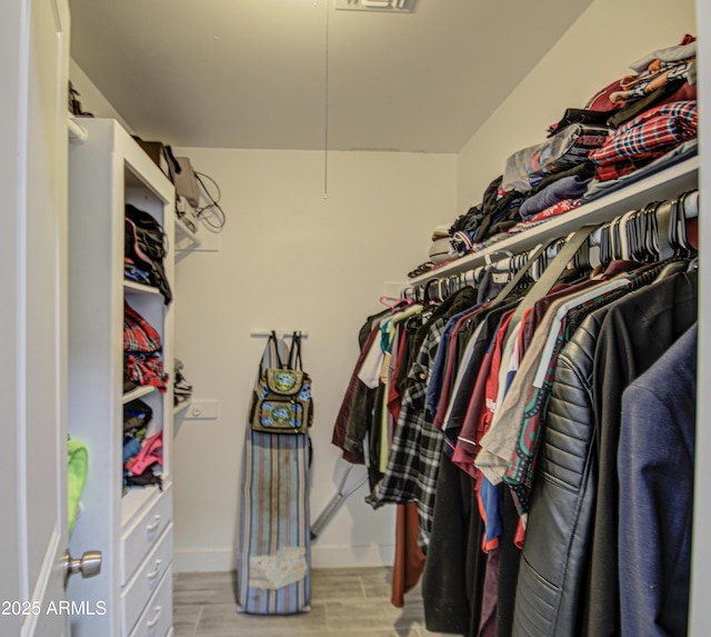 walk in closet featuring wood tiled floor