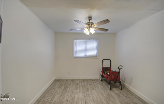 unfurnished room featuring a ceiling fan, light wood-style flooring, and baseboards