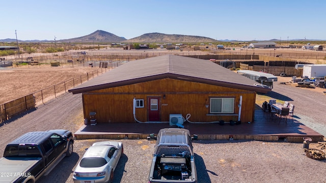 view of property exterior featuring a deck with mountain view