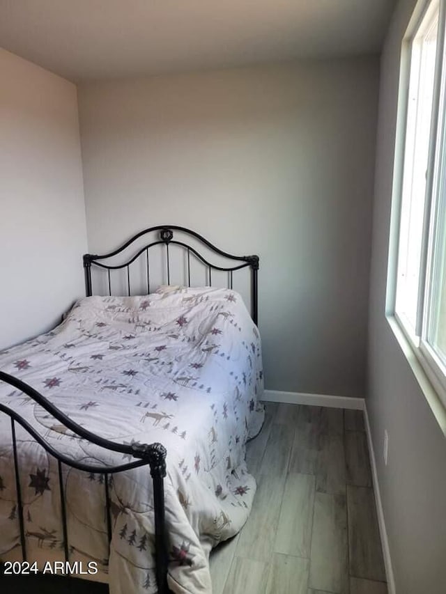 bedroom with hardwood / wood-style flooring