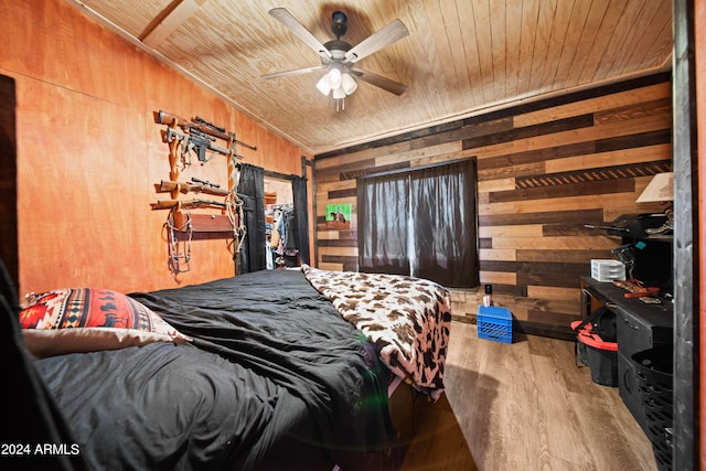 bedroom with wooden walls, ceiling fan, wooden ceiling, and hardwood / wood-style flooring