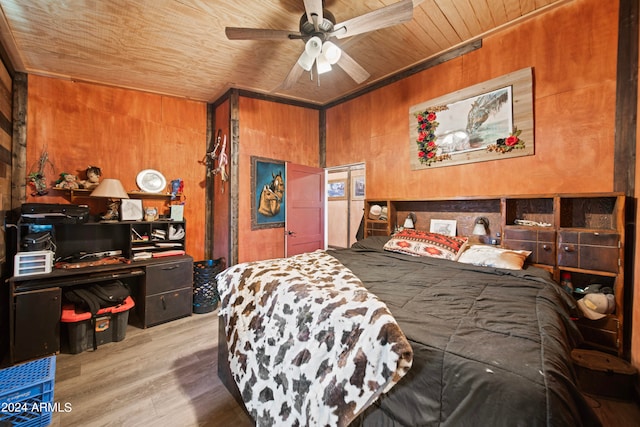 bedroom featuring hardwood / wood-style floors, ceiling fan, wood walls, and wood ceiling