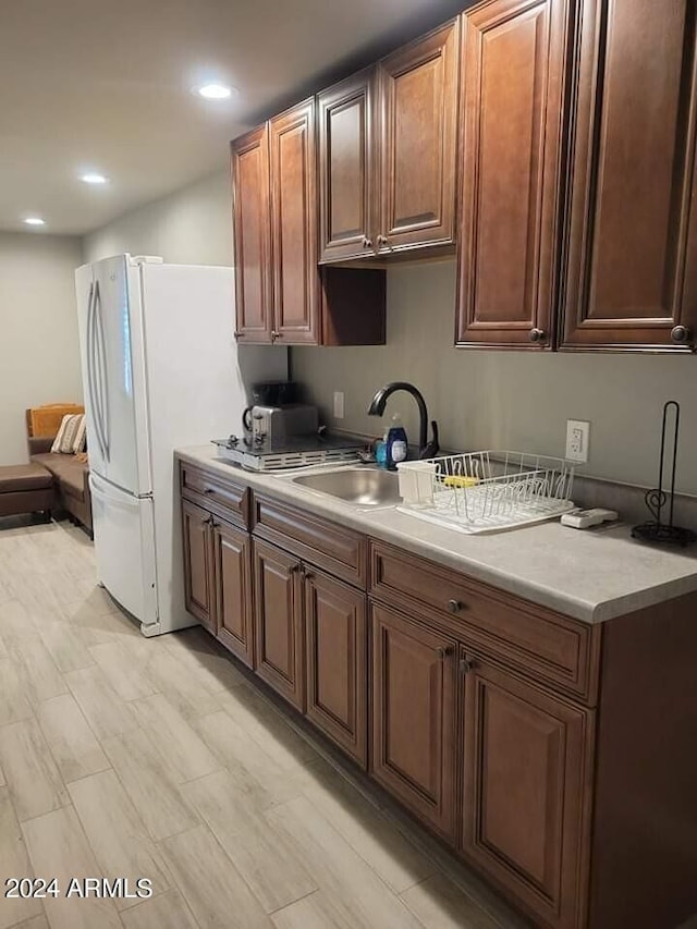 kitchen featuring white fridge and sink