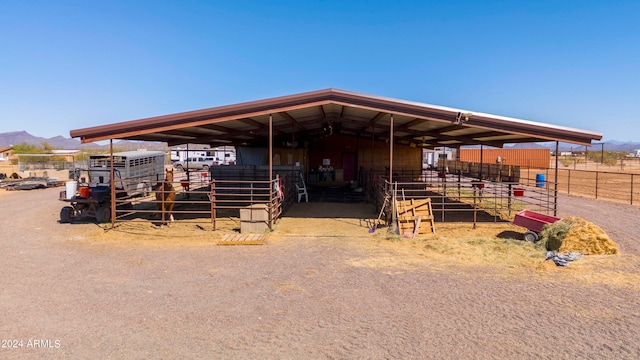 view of horse barn with a mountain view